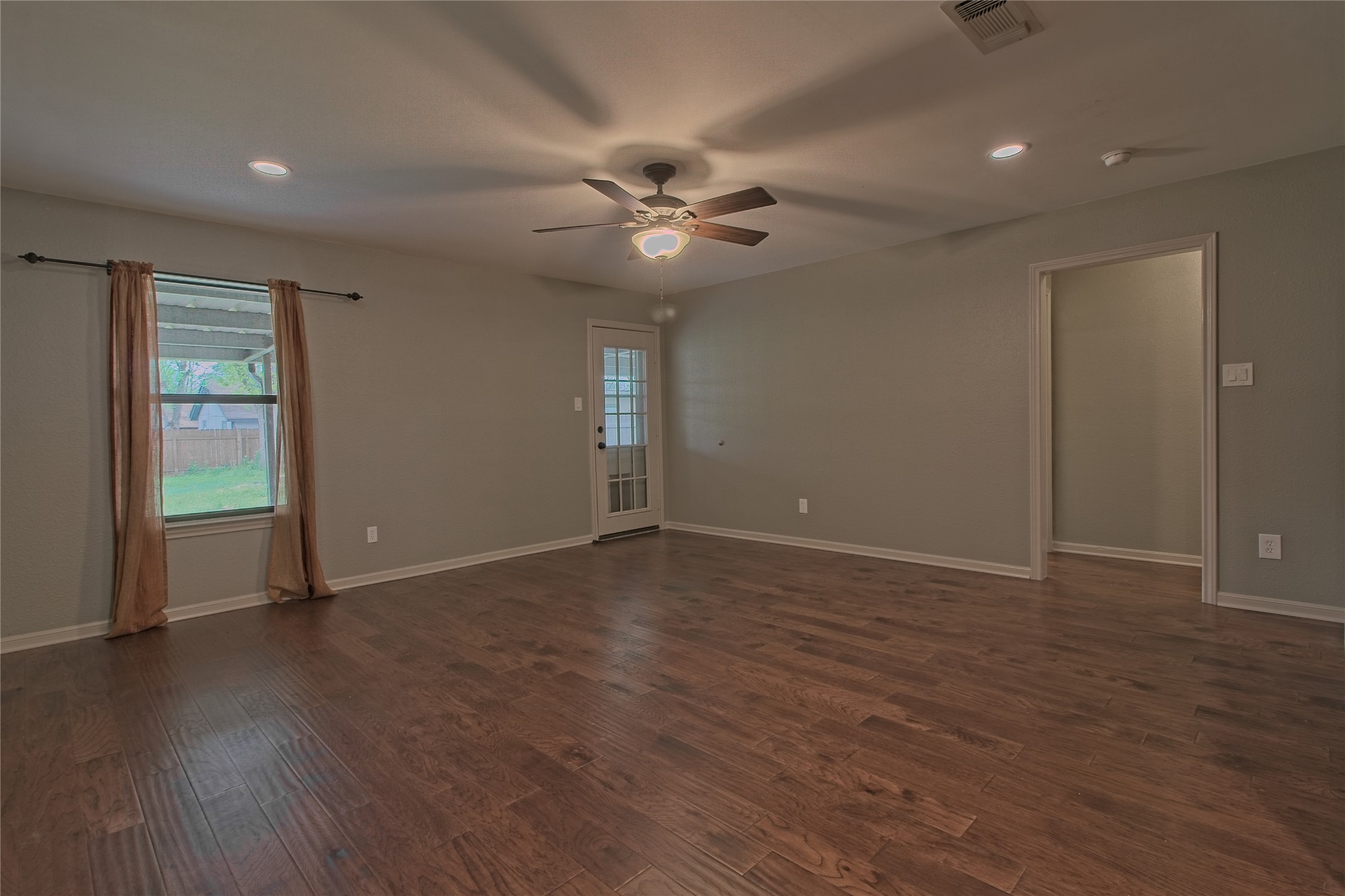 1102 Fowzer Street Taylor, TX 76574 - Photo 7 of 27 Empty room featuring dark wood-style floors, recessed lighting, and ceiling fan