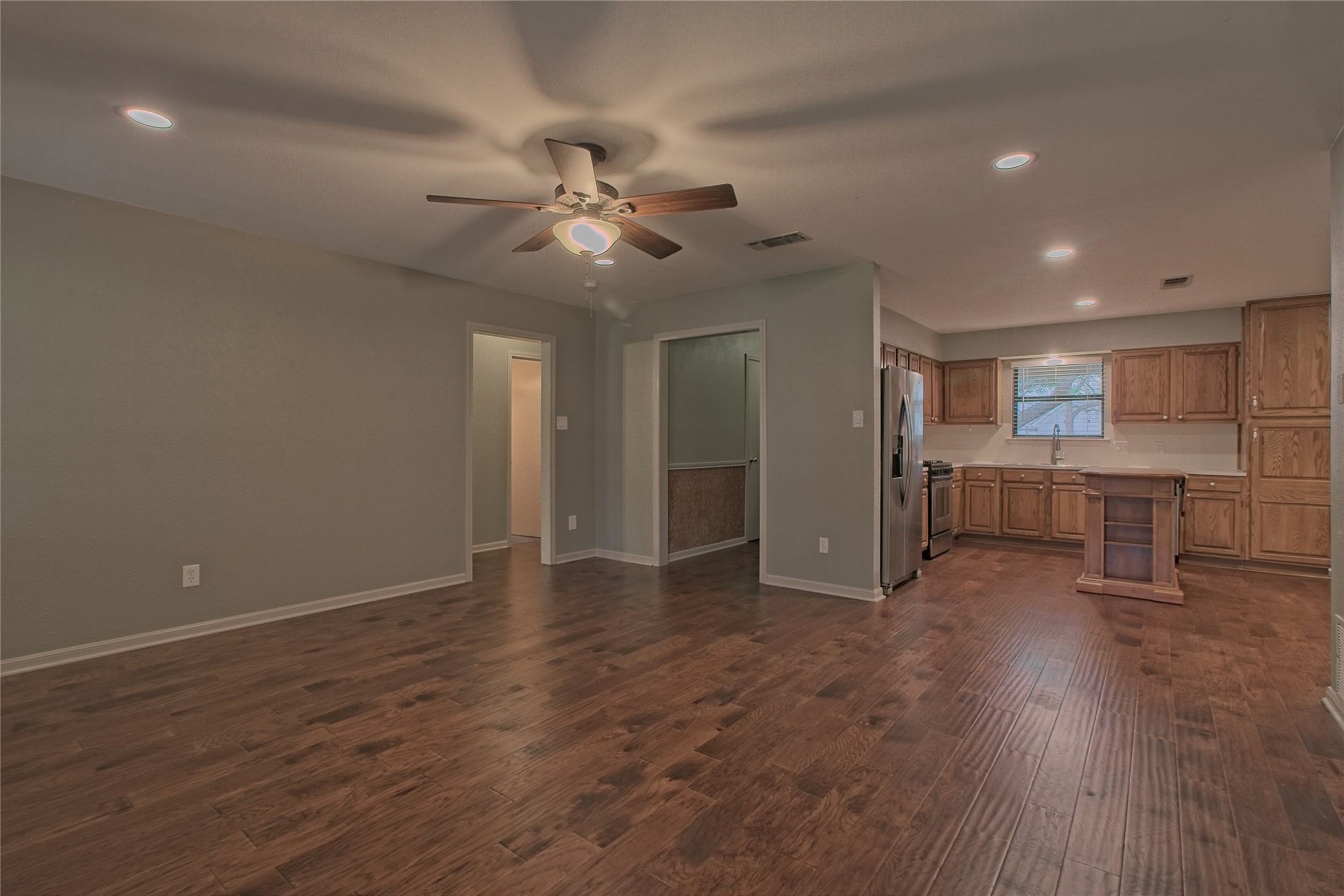 1102 Fowzer Street Taylor, TX 76574 - Photo 8 of 27 Unfurnished living room with recessed lighting, dark wood-type flooring, and ceiling fan