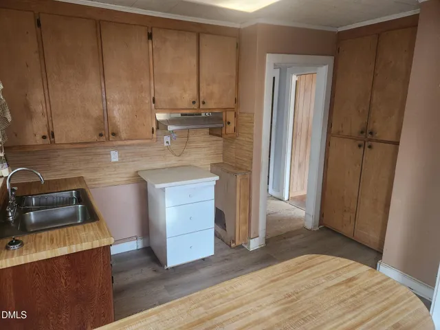 a kitchen with a sink and a refrigerator