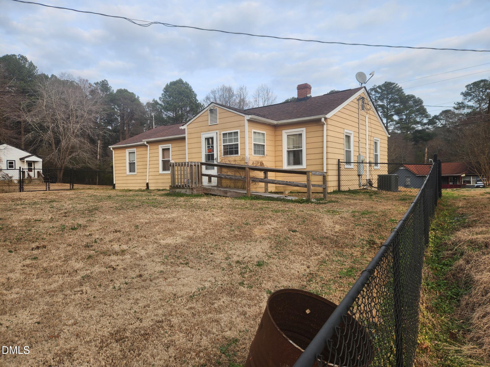 83 Wimberly Road Moncure, NC 27559 - Photo 2 of 17 a front view of a house with garden