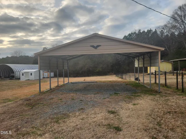 a backyard of a house with table and chairs