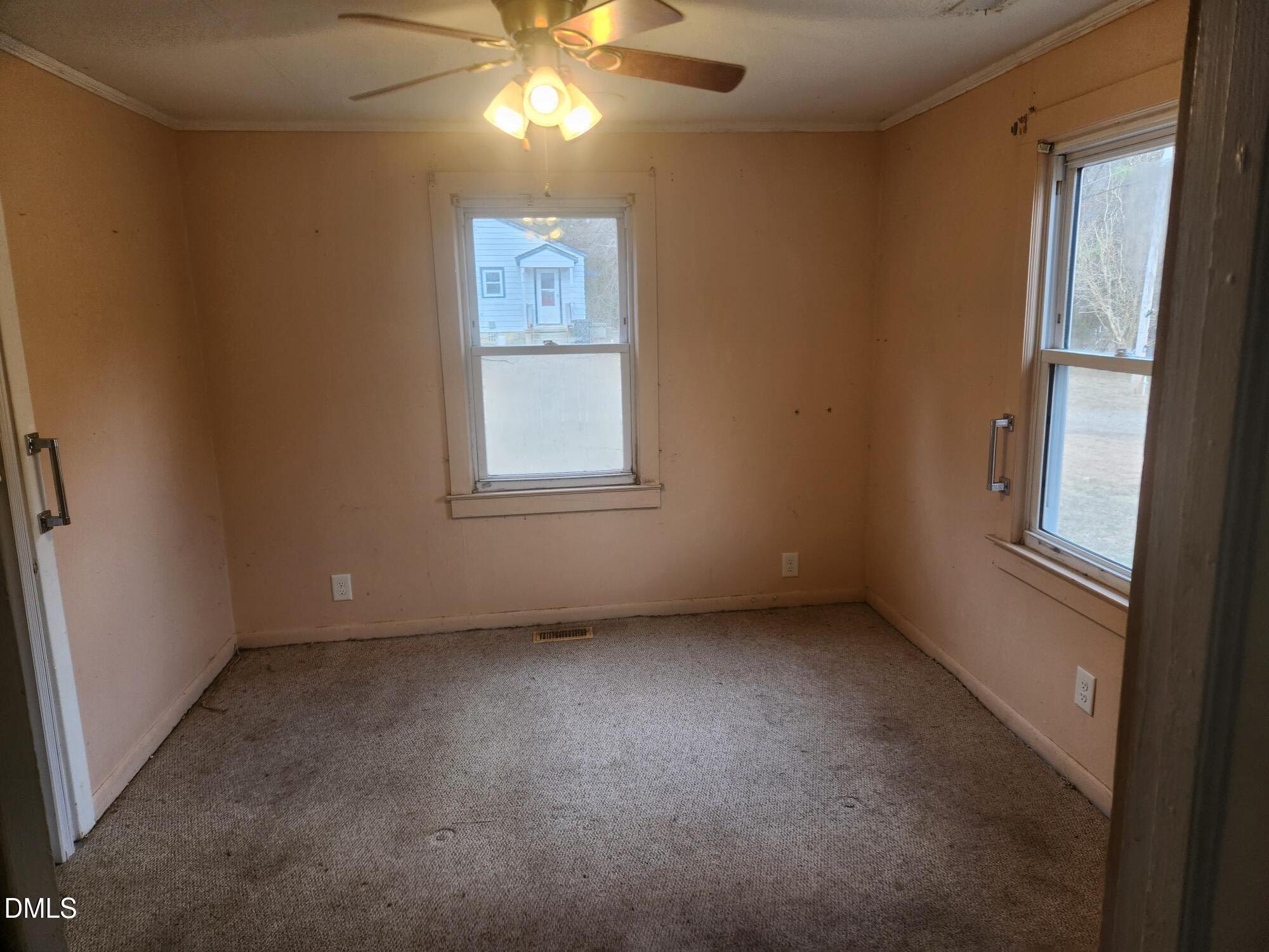 83 Wimberly Road Moncure, NC 27559 - Photo 9 of 17 an empty room with windows and fan