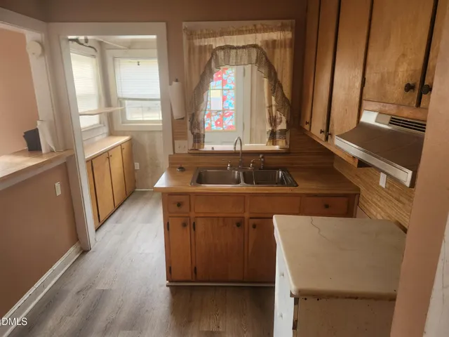 a kitchen with a sink and a stove top oven
