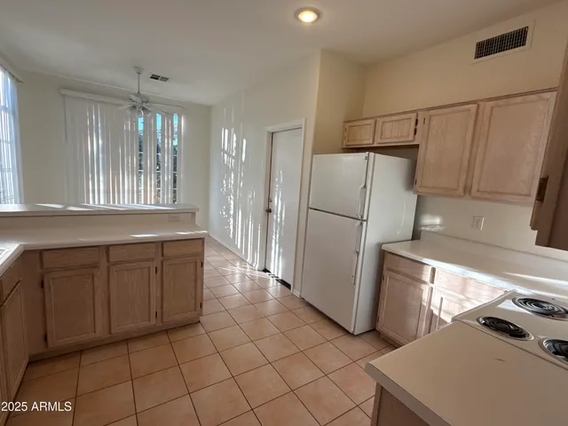 a kitchen with granite countertop a refrigerator and a sink