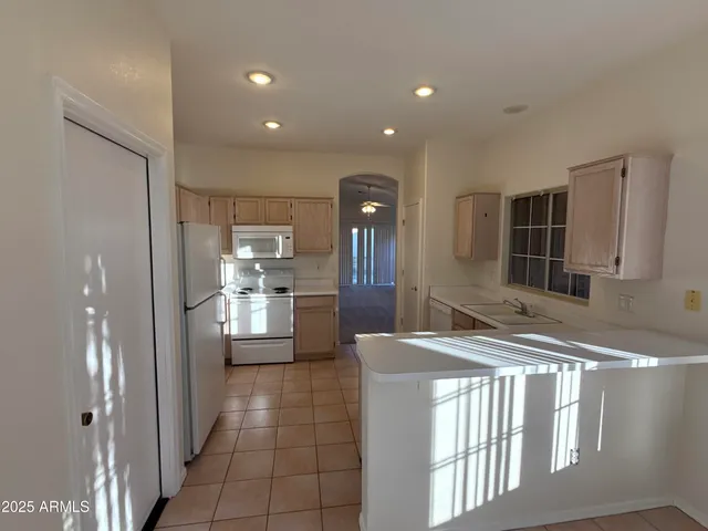 a bathroom with a sink a counter top space and stainless steel appliances