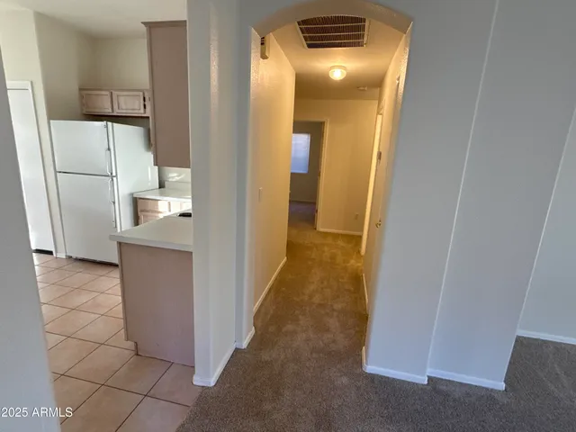 a view of a bathroom from a corridor