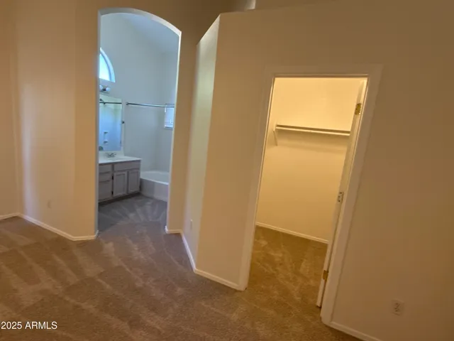 a bathroom with a tub sink mirror vanity and toilet