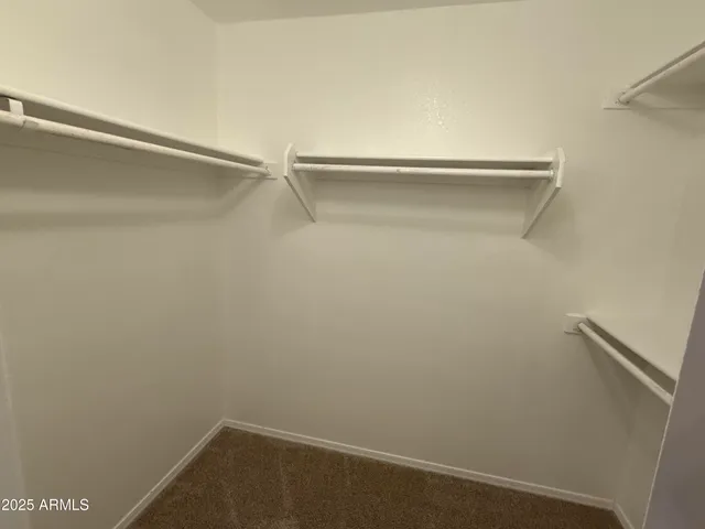 an empty room with closet and entryway