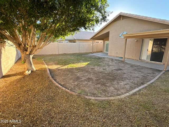 a view of a house with a backyard