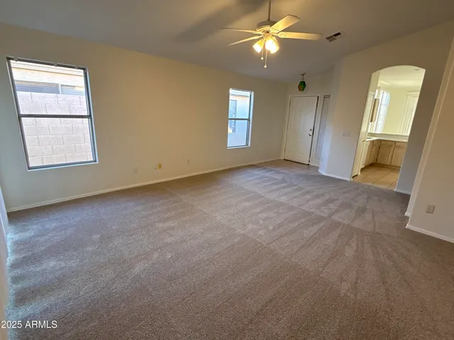 an empty room with windows and entrance