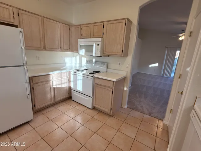 a kitchen with a stove a sink and a refrigerator