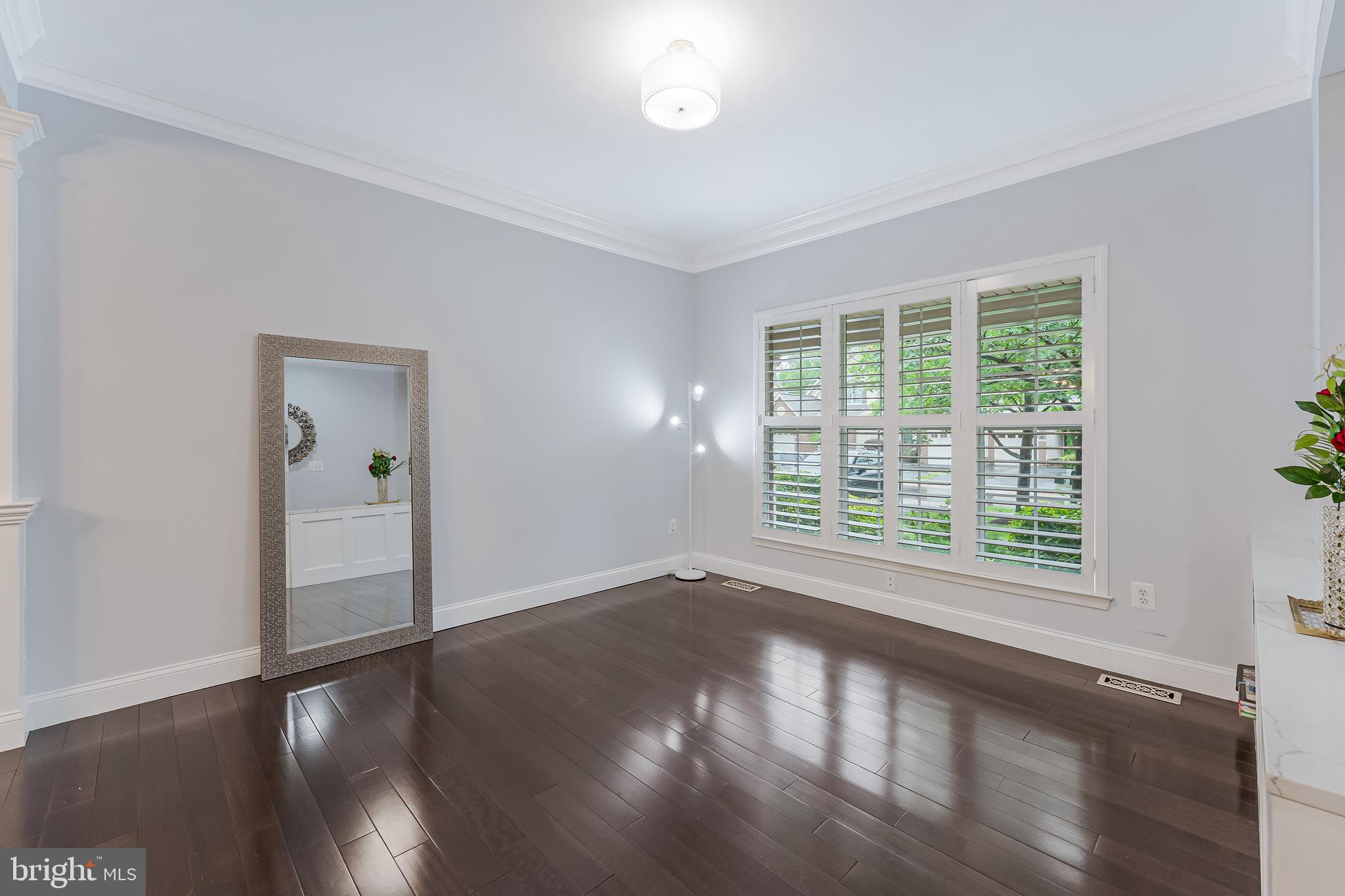 19599 Aspendale Square Ashburn, VA 20147 - Photo 12 of 56 a view of an empty room with wooden floor and a window