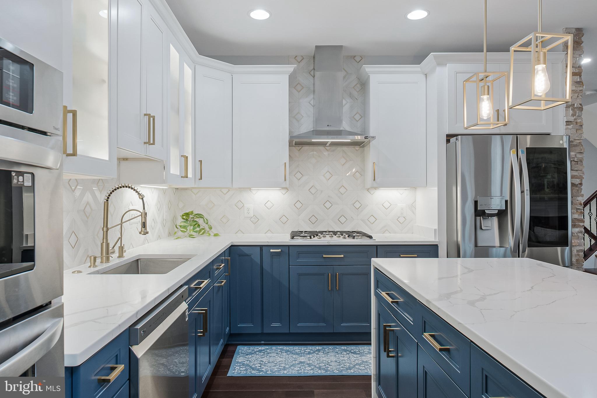 19599 Aspendale Square Ashburn, VA 20147 - Photo 15 of 56 a kitchen with stainless steel appliances granite countertop a sink stove and refrigerator