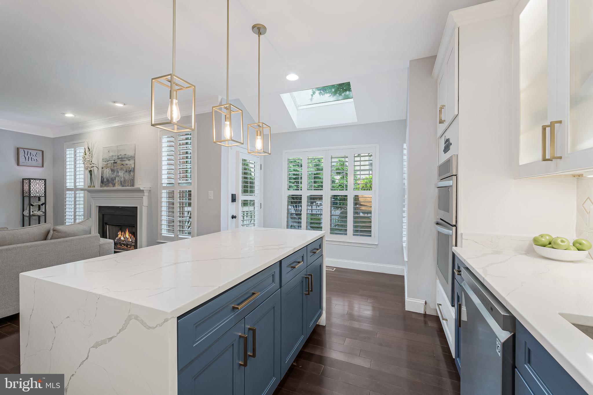 19599 Aspendale Square Ashburn, VA 20147 - Photo 17 of 56 a kitchen with a sink a stove and a refrigerator