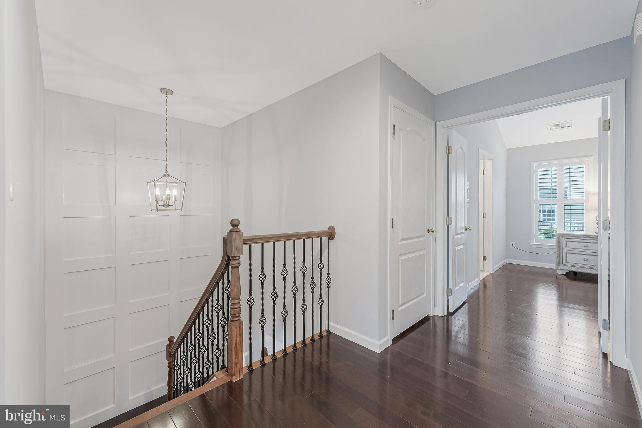 19599 Aspendale Square Ashburn, VA 20147 - Photo 28 of 56 a view of a hallway with wooden floor and stairs