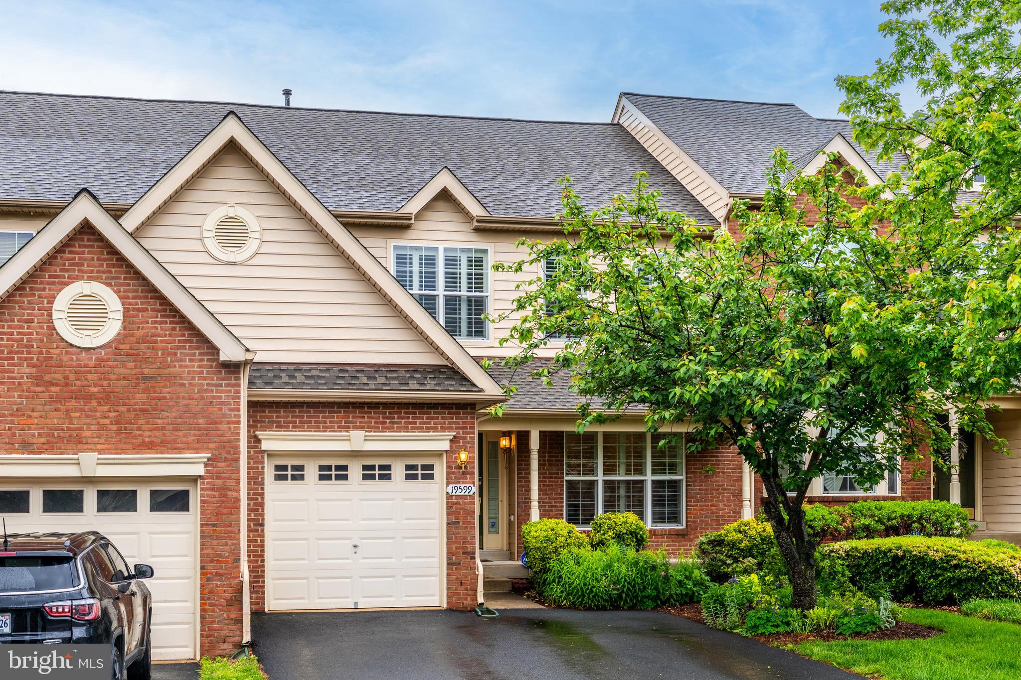19599 Aspendale Square Ashburn, VA 20147 - Photo 3 of 56 a view of house with a yard and potted plants