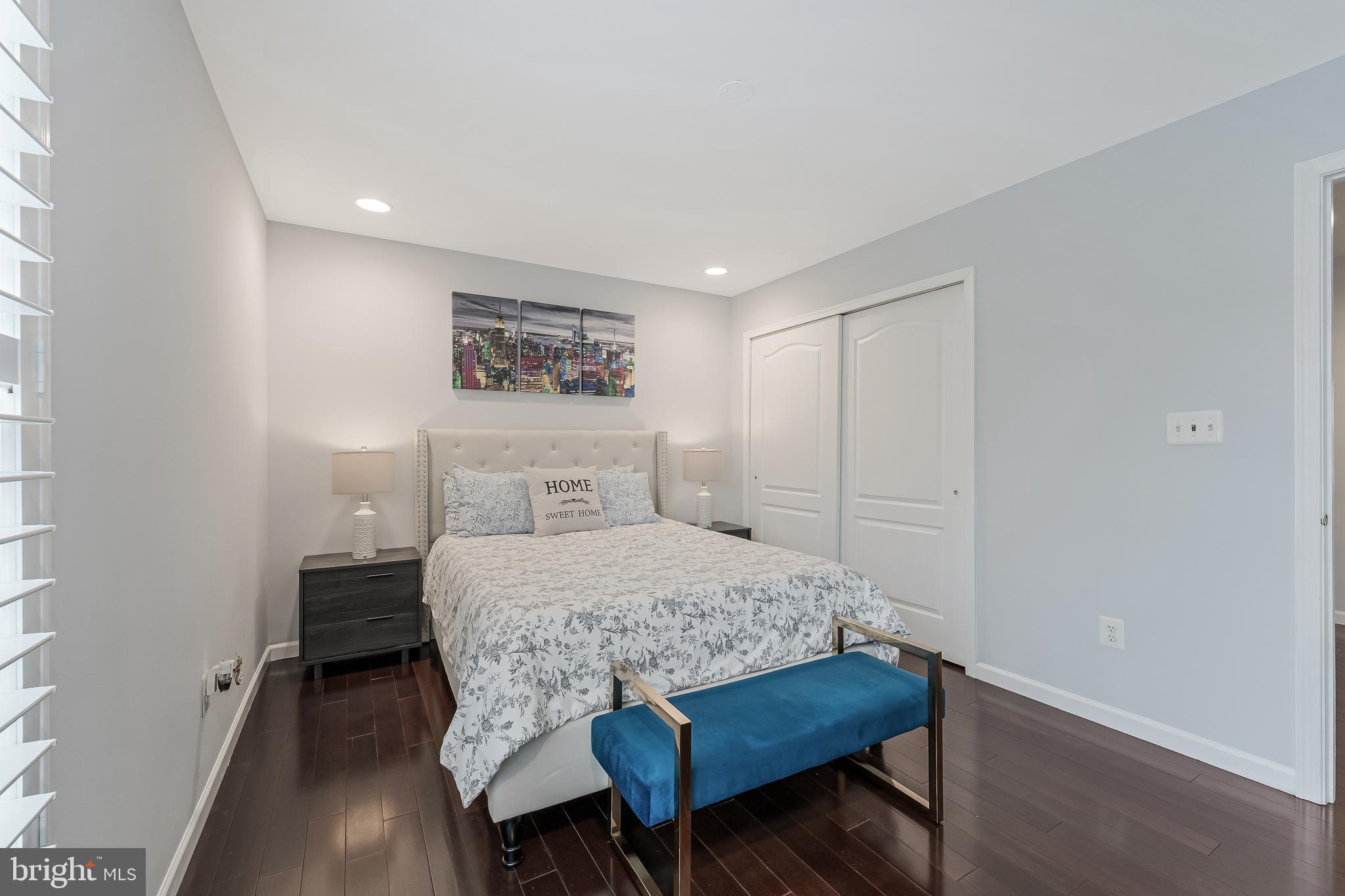 19599 Aspendale Square Ashburn, VA 20147 - Photo 38 of 56 a bedroom with a bed and a table in it