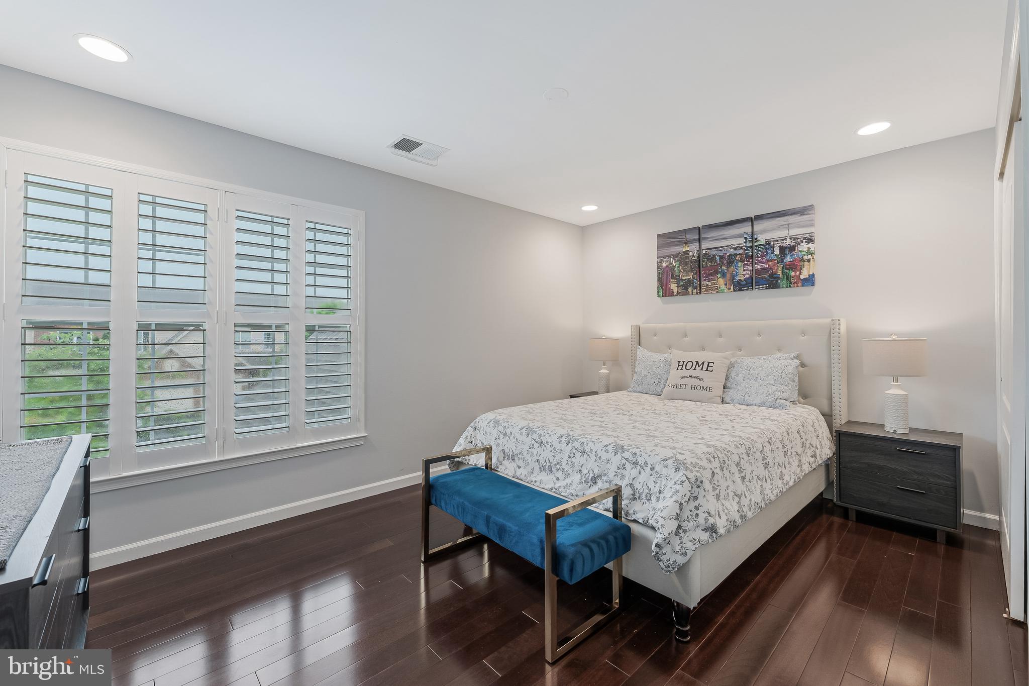 19599 Aspendale Square Ashburn, VA 20147 - Photo 39 of 56 a bedroom with a bed table and a window