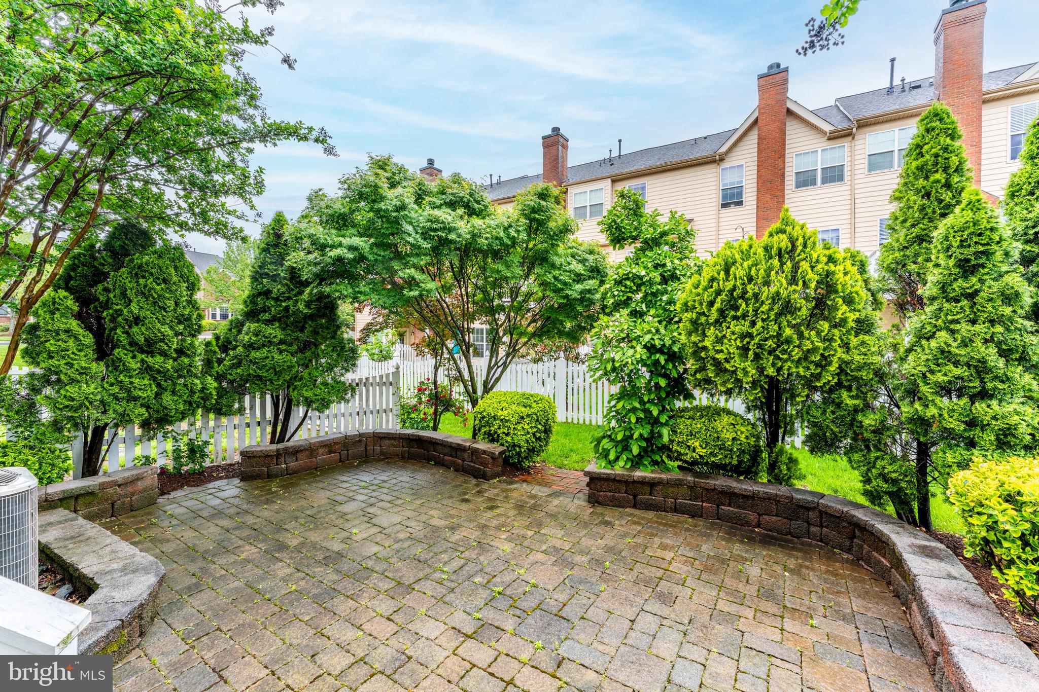 19599 Aspendale Square Ashburn, VA 20147 - Photo 5 of 56 a front view of a house with a yard and a garage