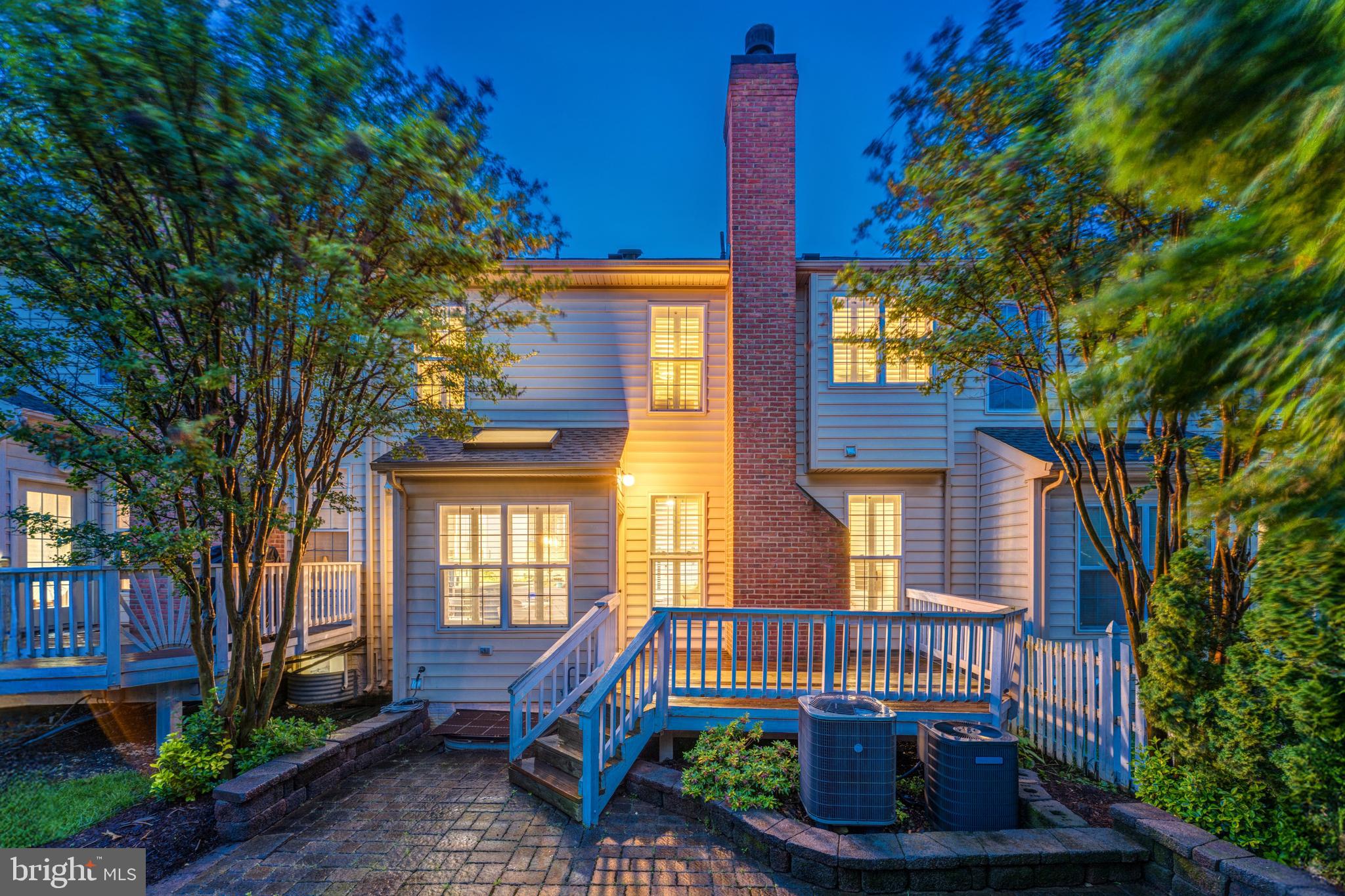 19599 Aspendale Square Ashburn, VA 20147 - Photo 7 of 56 a front view of a house with a garden