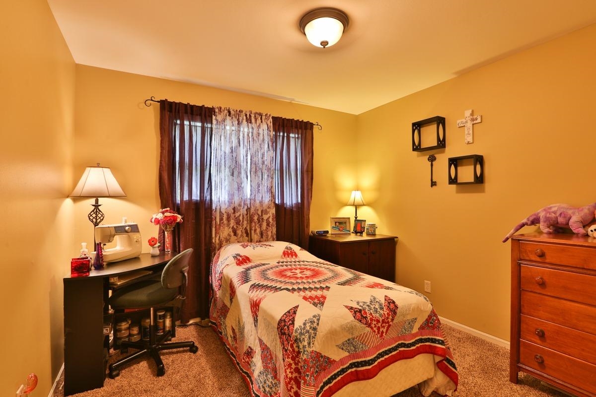 1035 North Indiana Street Griffith, IN 46319 - Photo 8 of 10 a bedroom with a bed and wooden floor