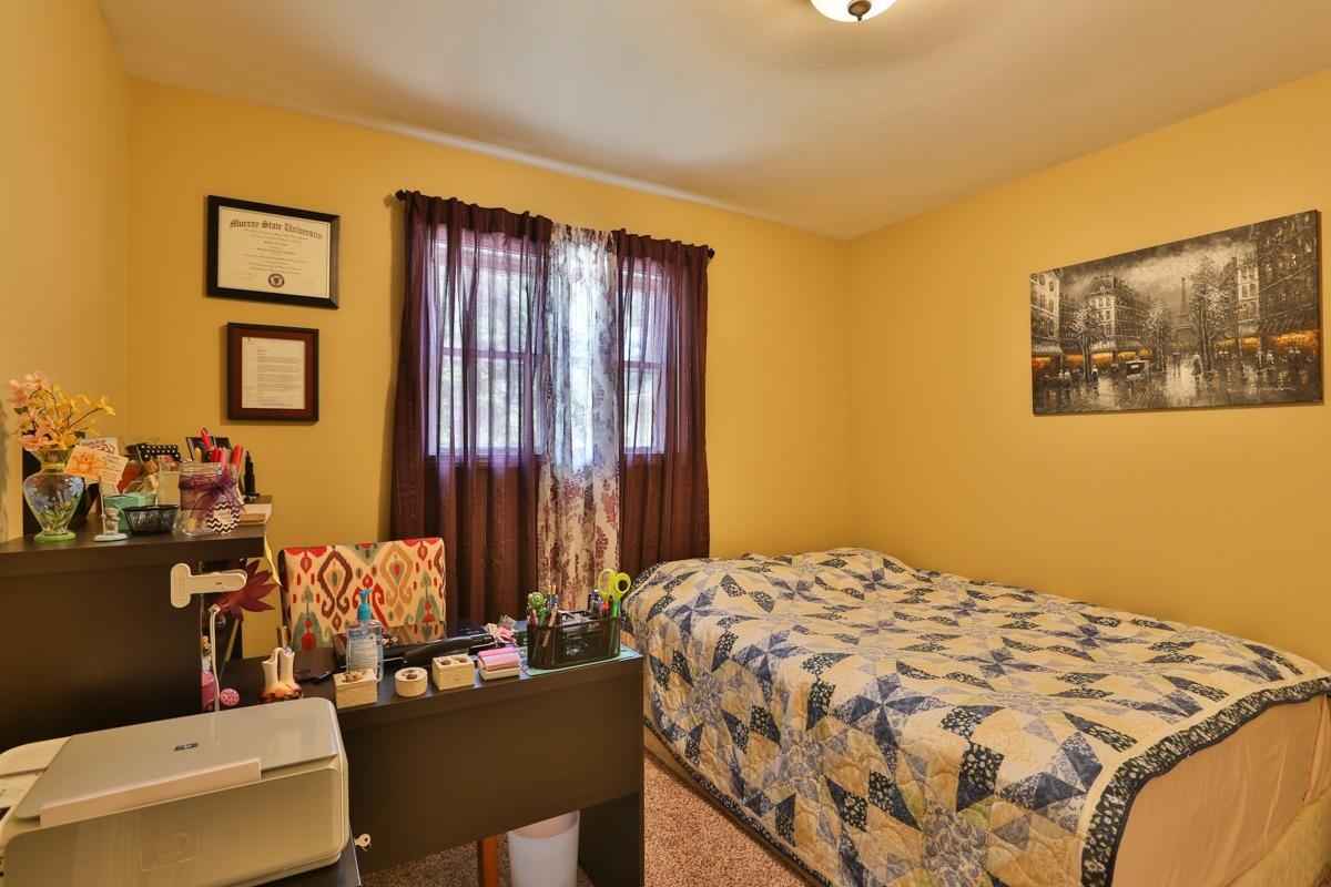 1035 North Indiana Street Griffith, IN 46319 - Photo 9 of 10 a bedroom with a bed and a painting on the wall