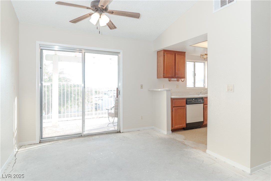2225 Pebble Creek Lane Laughlin, NV 89029 - Photo 11 of 87 Unfurnished dining area with a ceiling fan, concrete flooring, and lofted ceiling