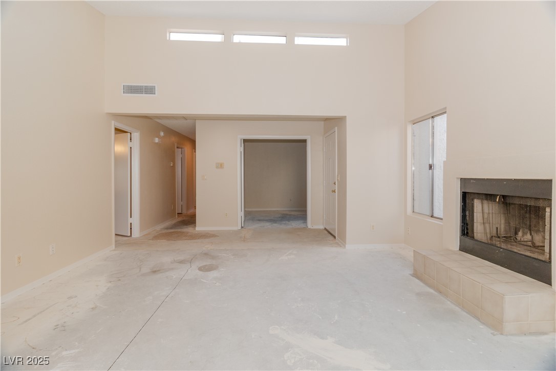 2225 Pebble Creek Lane Laughlin, NV 89029 - Photo 19 of 87 Unfurnished living room with a towering ceiling and a fireplace
