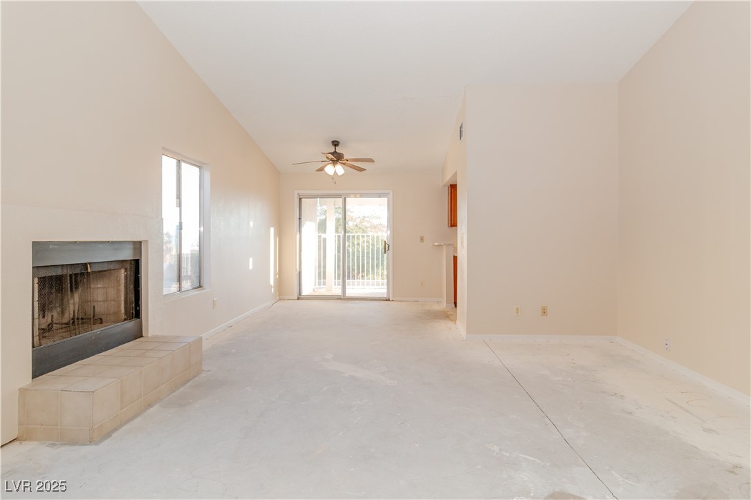 2225 Pebble Creek Lane Laughlin, NV 89029 - Photo 20 of 87 Unfurnished living room with a tile fireplace, unfinished concrete floors, and ceiling fan