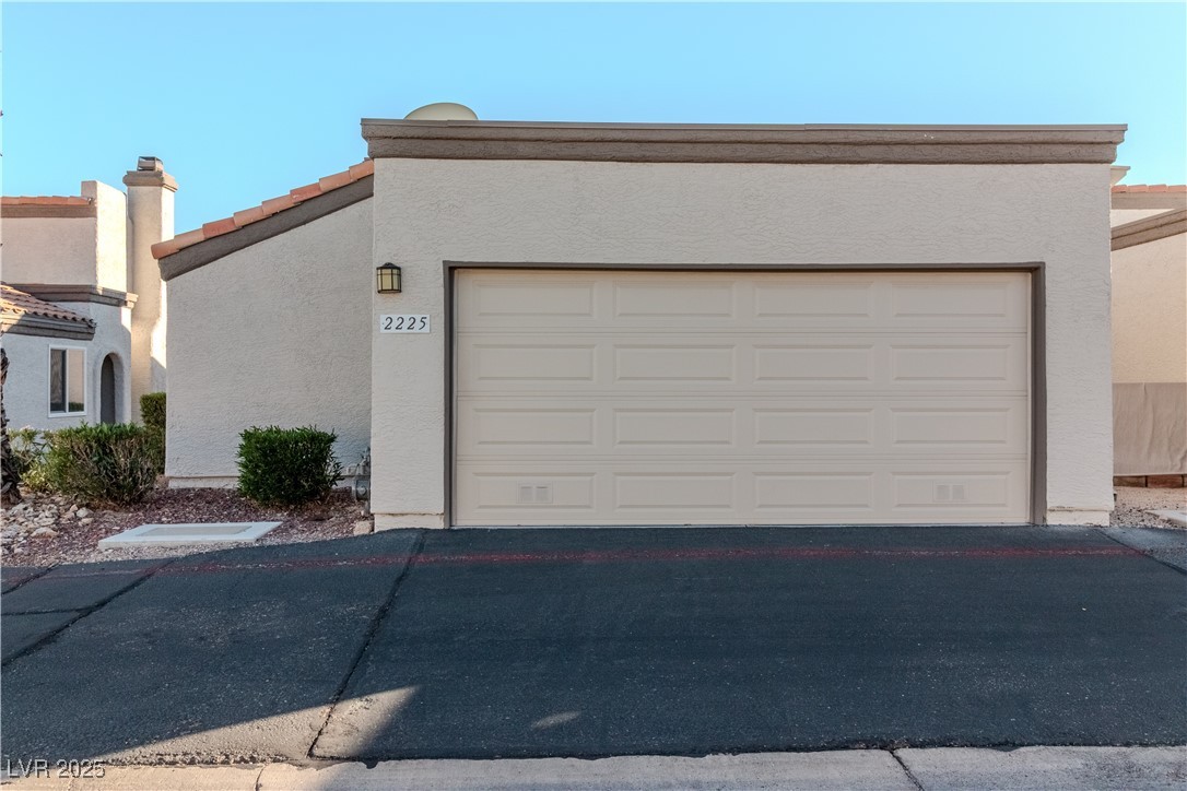 2225 Pebble Creek Lane Laughlin, NV 89029 - Photo 2 of 87 View of front of house with stucco siding and driveway