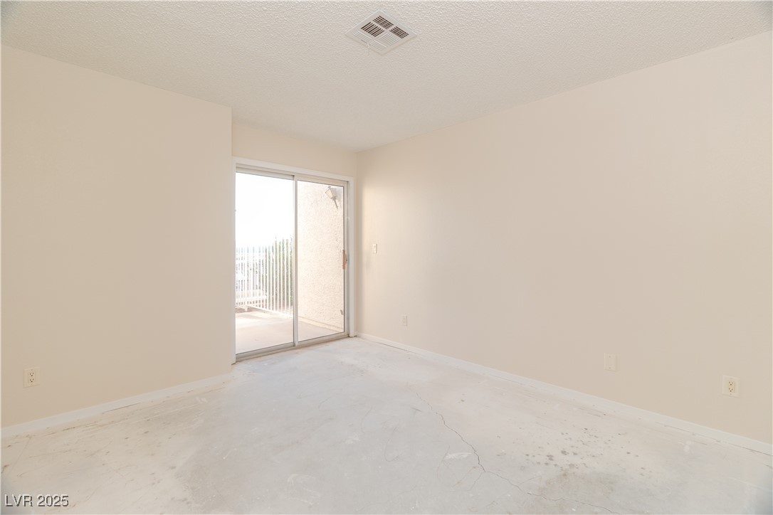 2225 Pebble Creek Lane Laughlin, NV 89029 - Photo 21 of 87 Primary Bedroom featuring a textured ceiling and unfinished concrete flooring