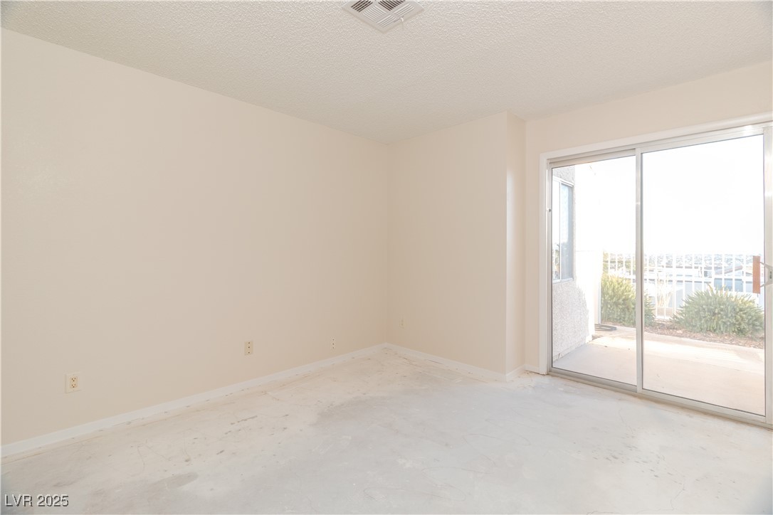 2225 Pebble Creek Lane Laughlin, NV 89029 - Photo 22 of 87 Primary Bedroom with a textured ceiling and concrete floors