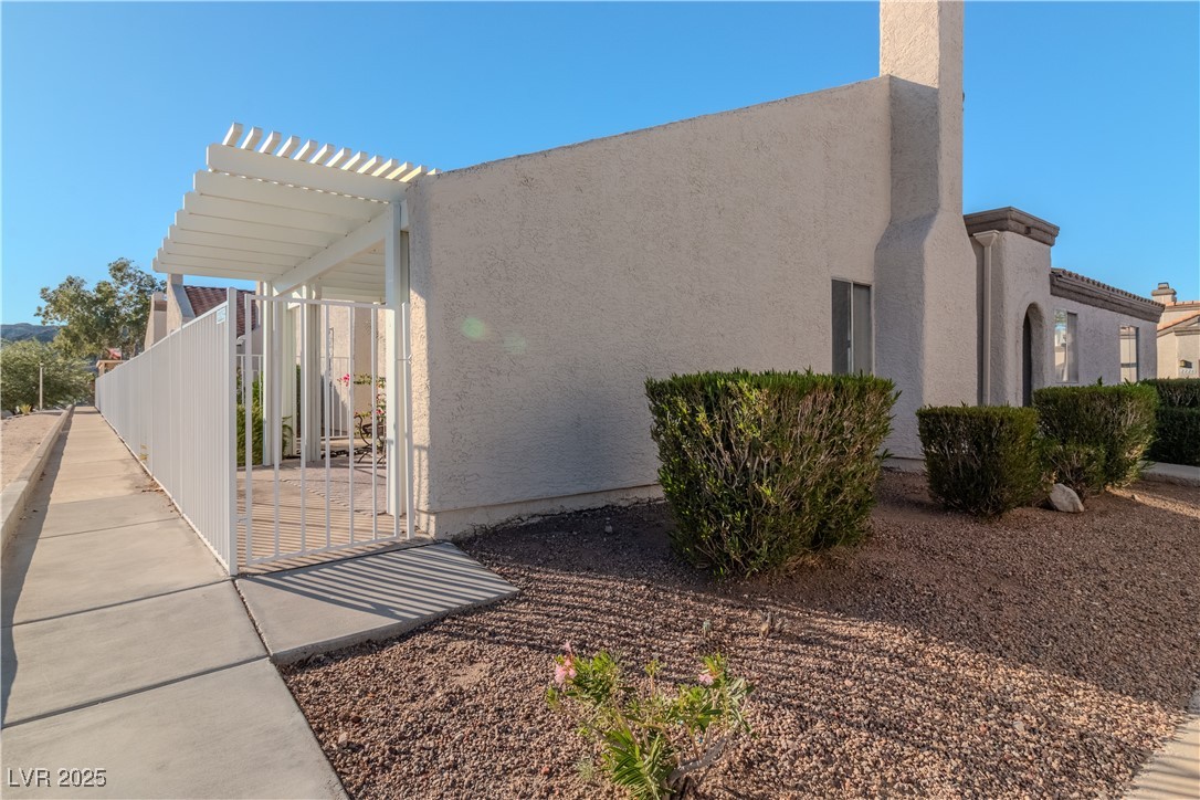2225 Pebble Creek Lane Laughlin, NV 89029 - Photo 42 of 87 View of side of home with stucco siding and a gate