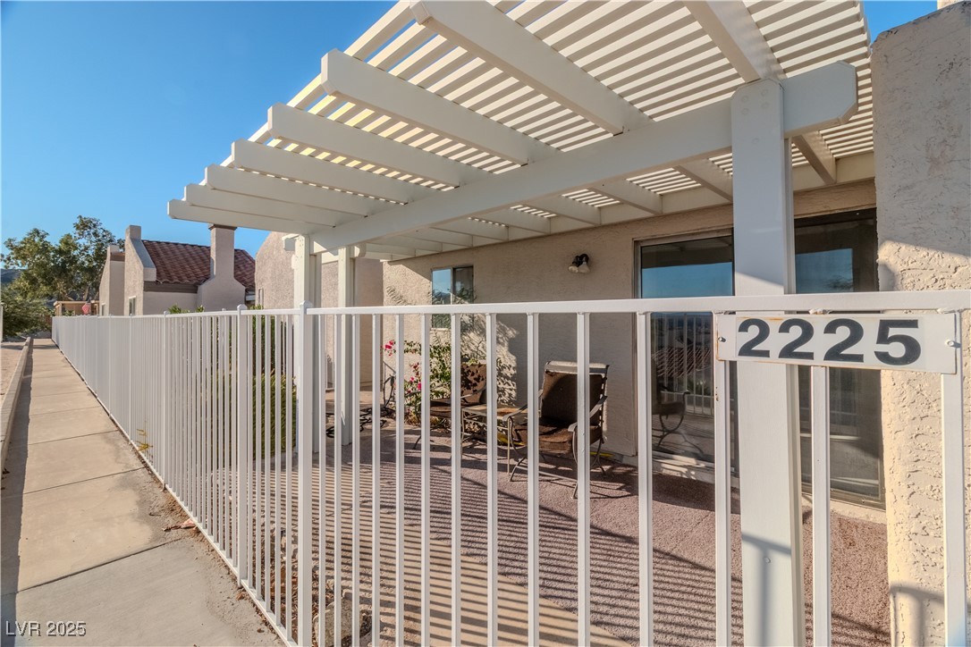 2225 Pebble Creek Lane Laughlin, NV 89029 - Photo 43 of 87 Gate featuring a pergola