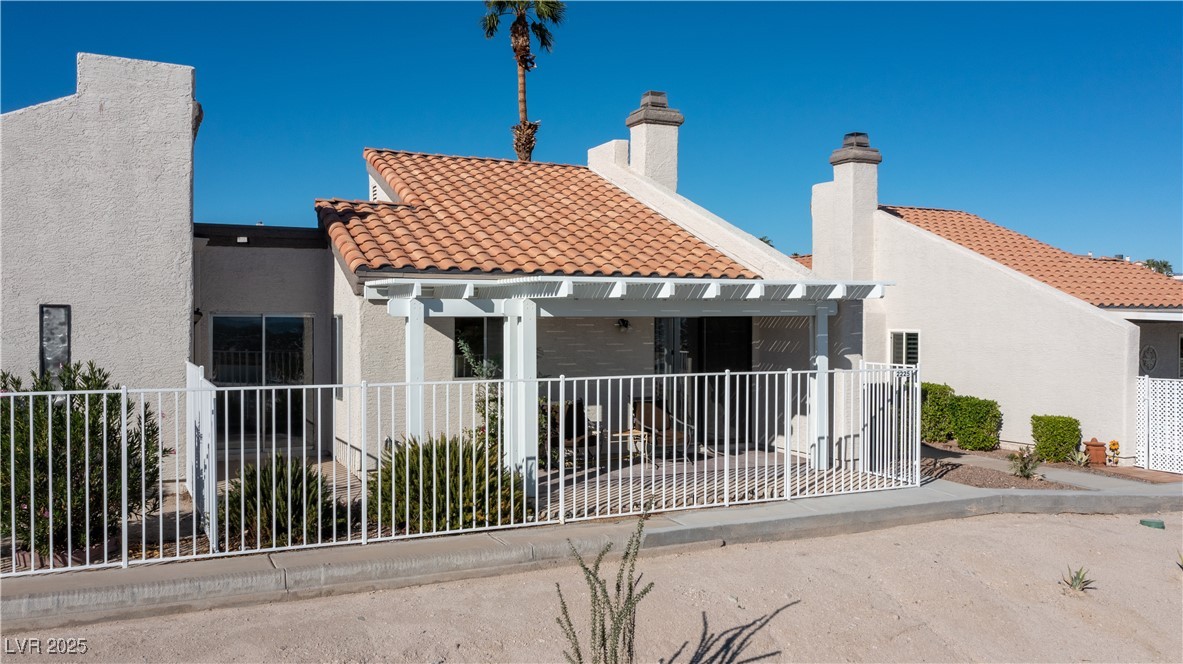 2225 Pebble Creek Lane Laughlin, NV 89029 - Photo 74 of 87 View of back of house featuring a mountain view, stucco siding, and a patio area