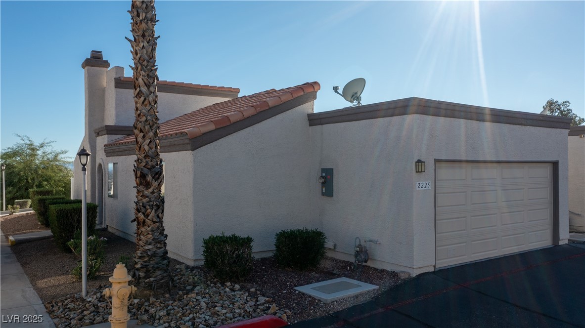 2225 Pebble Creek Lane Laughlin, NV 89029 - Photo 82 of 87 View of side of home with a garage and stucco siding