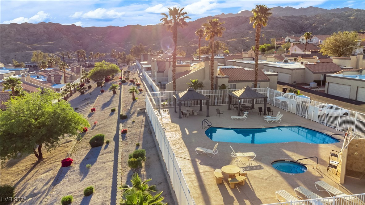 2225 Pebble Creek Lane Laughlin, NV 89029 - Photo 83 of 87 Community pool featuring a mountain view, a community hot tub, a residential view, and a patio