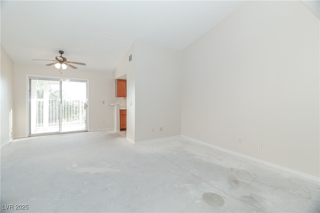 2225 Pebble Creek Lane Laughlin, NV 89029 - Photo 10 of 87 Unfurnished living room featuring concrete flooring, a ceiling fan, and lofted ceiling