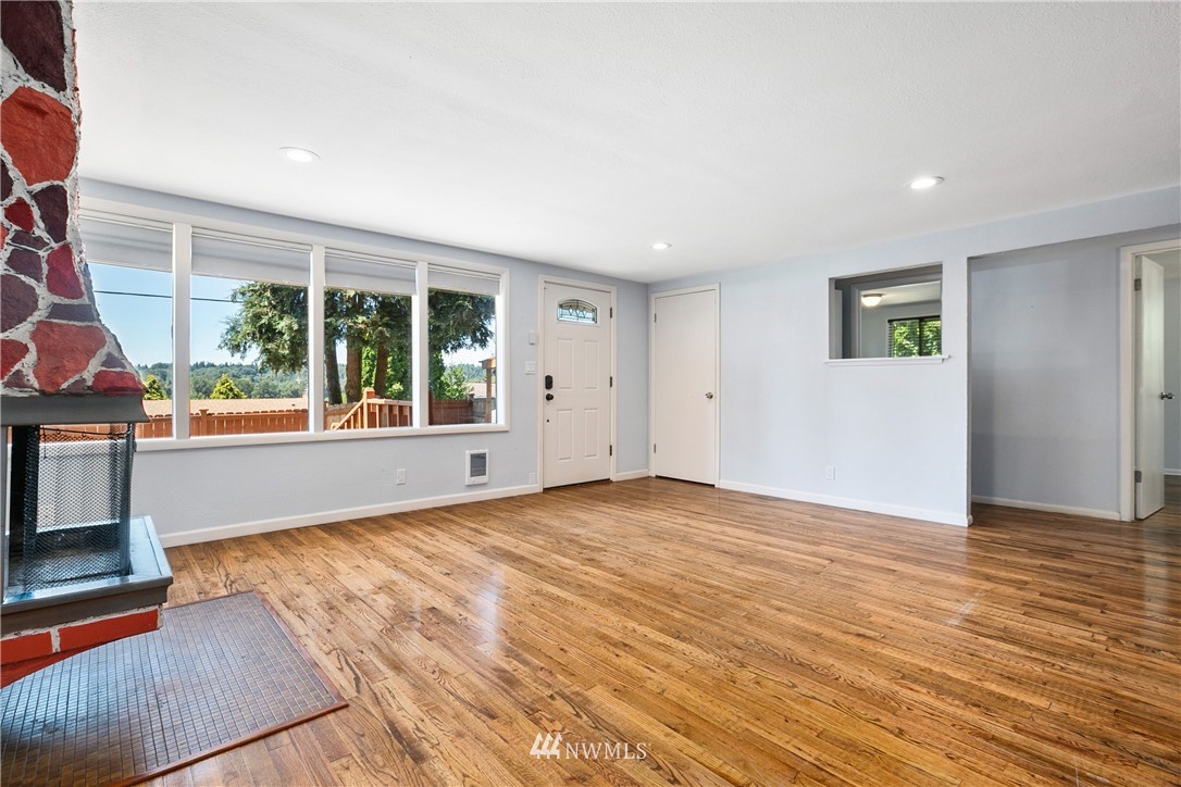 23925 7th Avenue West Bothell, WA 98021 - Photo 14 of 28 a view of an empty room with wooden floor and a window