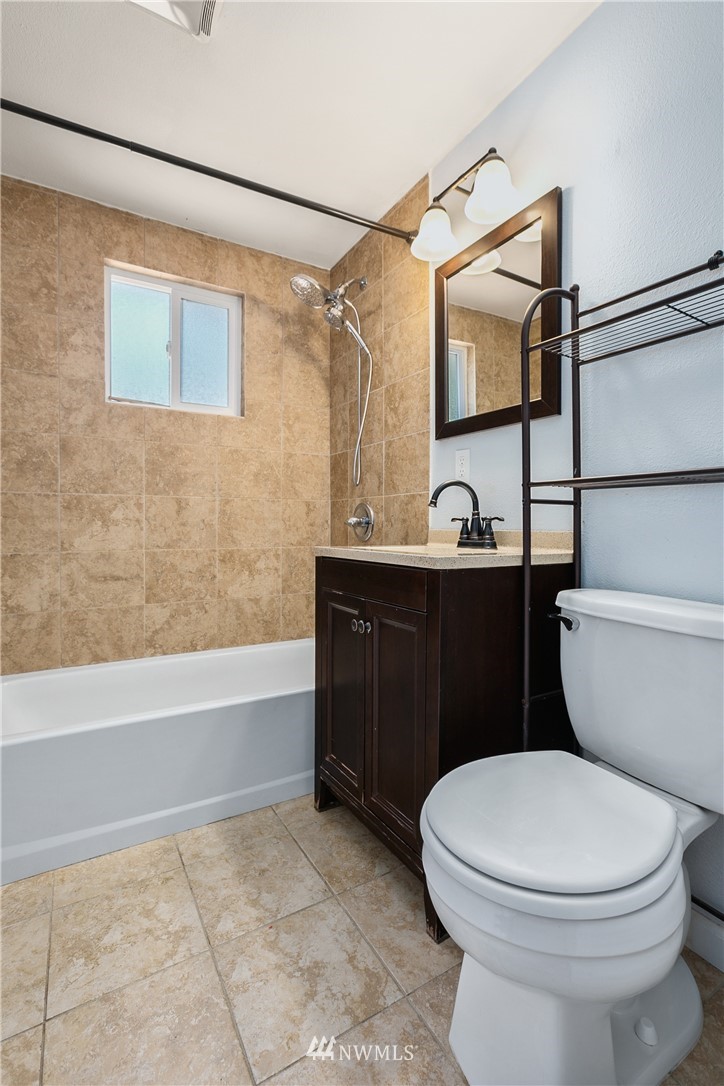 23925 7th Avenue West Bothell, WA 98021 - Photo 16 of 28 a bathroom with a sink a toilet a mirror and bathtub
