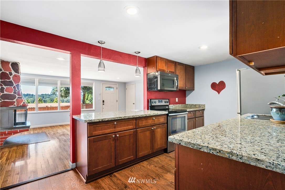 23925 7th Avenue West Bothell, WA 98021 - Photo 7 of 28 a kitchen with kitchen island granite countertop a sink and counter top space