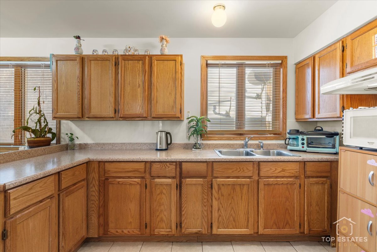 4629 South Laflin Street Chicago, IL 60609 - Photo 12 of 33 a kitchen with stainless steel appliances granite countertop a sink a stove and cabinets