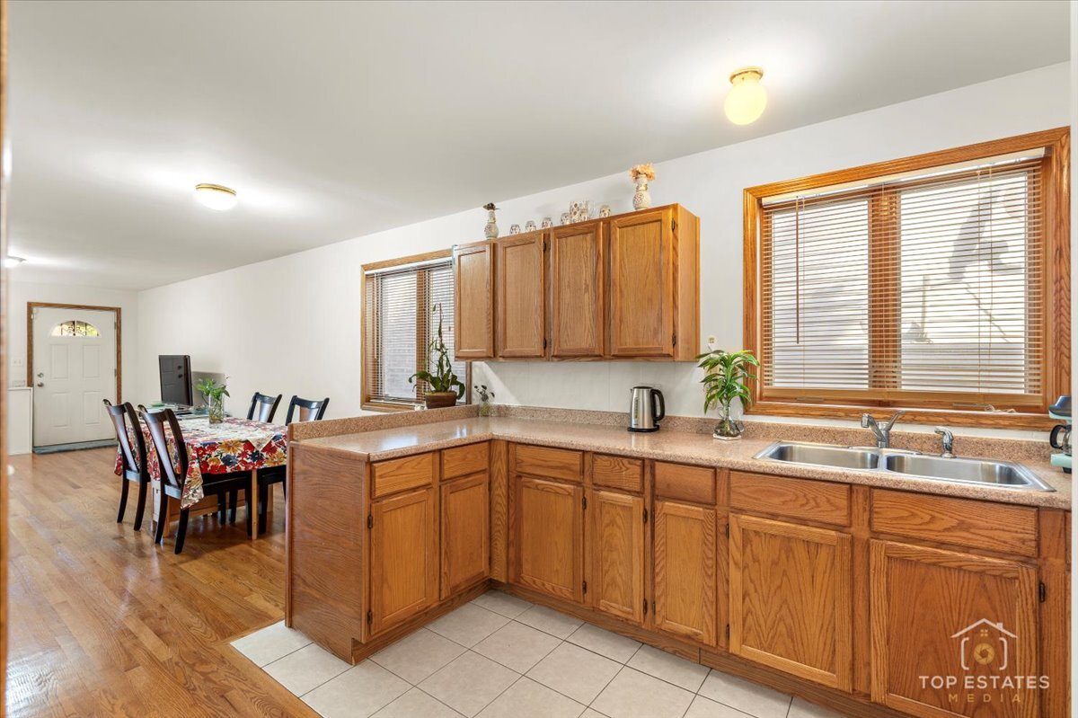 4629 South Laflin Street Chicago, IL 60609 - Photo 13 of 33 a kitchen with a sink table and chairs