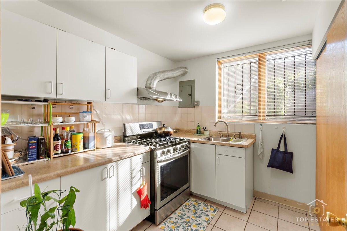 4629 South Laflin Street Chicago, IL 60609 - Photo 24 of 33 a kitchen with stainless steel appliances granite countertop a stove a sink and a refrigerator