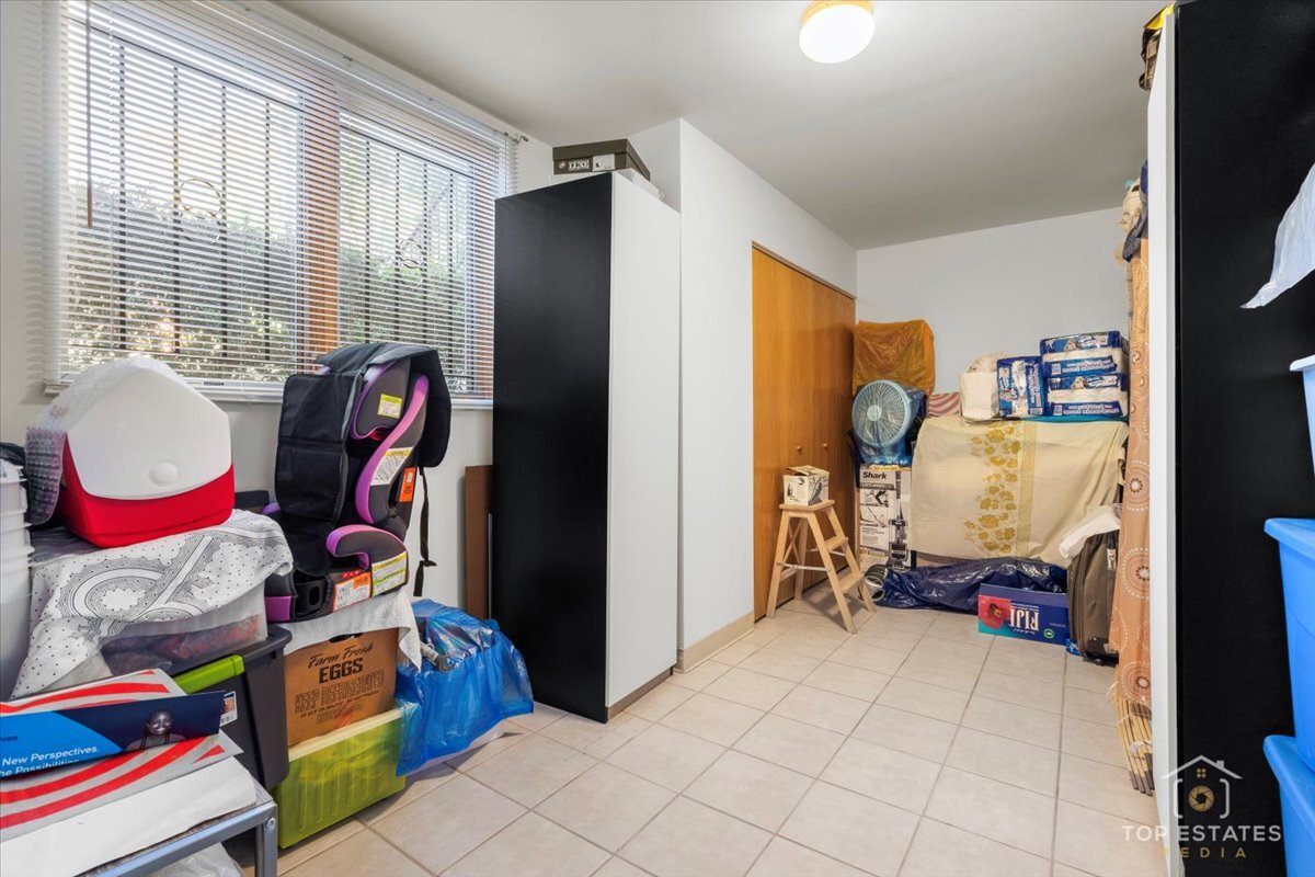 4629 South Laflin Street Chicago, IL 60609 - Photo 27 of 33 a living room filled with furniture and a flat screen tv