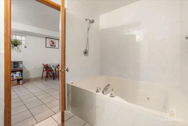 a bathroom with a bathtub and a shower