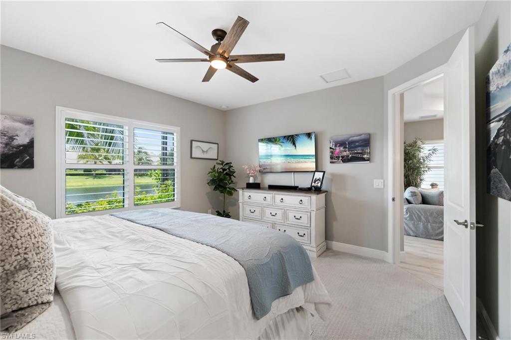 2298 Marquesa Circle Naples, FL 34112 - Photo 13 of 50 a bedroom with a large bed and a flat screen tv