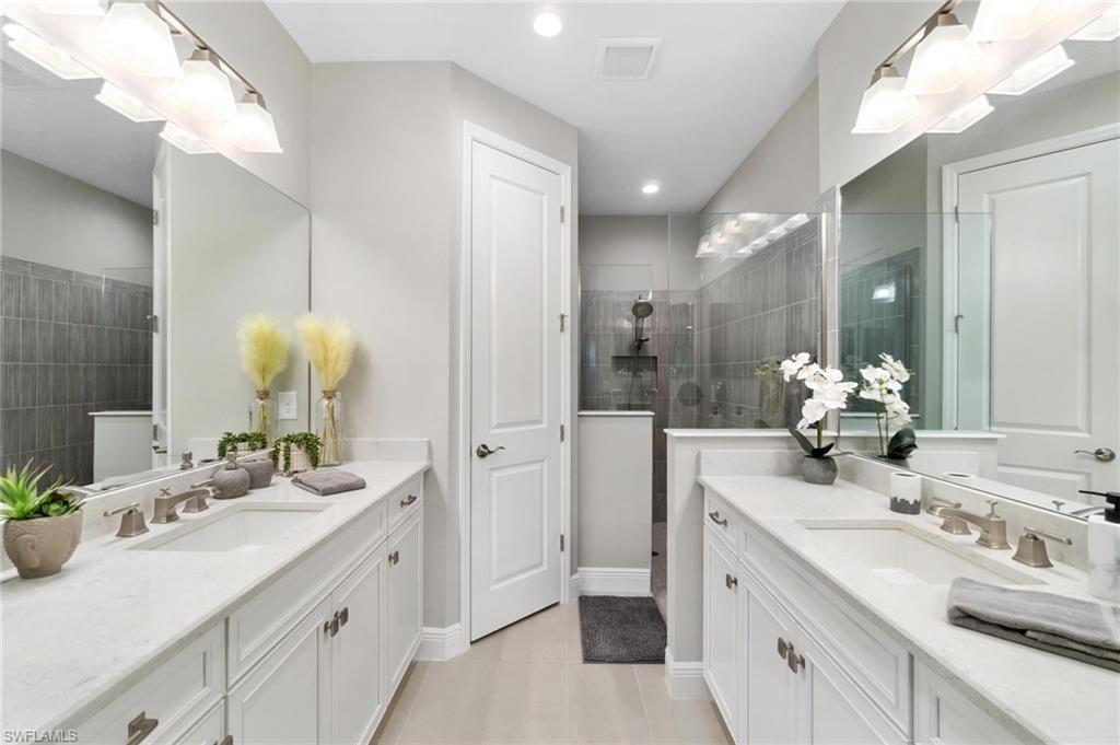 2298 Marquesa Circle Naples, FL 34112 - Photo 14 of 50 a bathroom with a sink double vanity and a mirror
