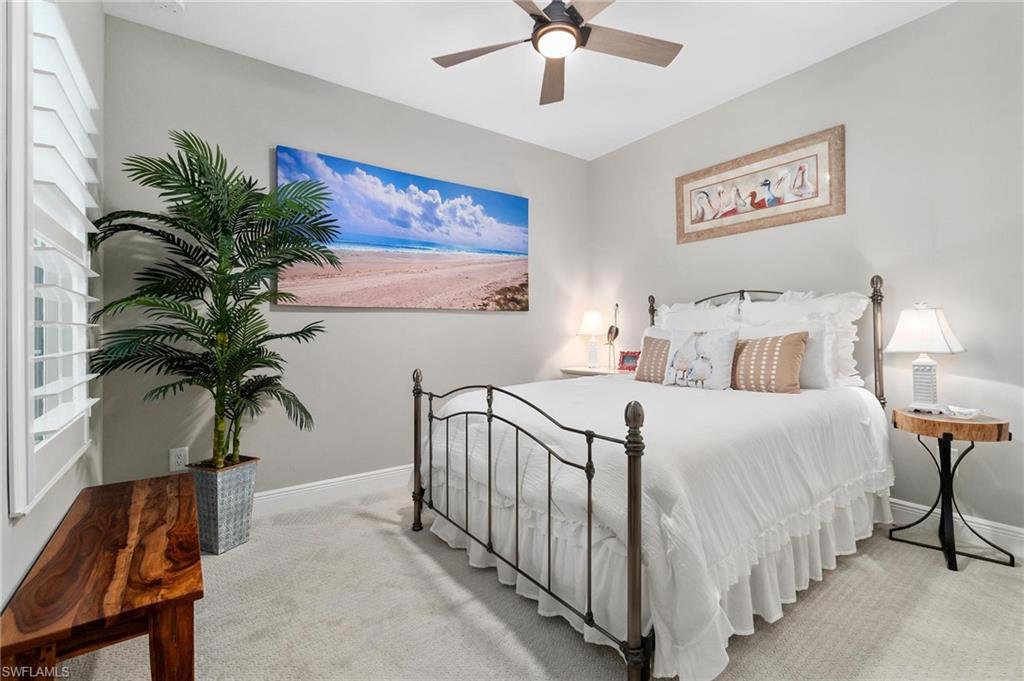 2298 Marquesa Circle Naples, FL 34112 - Photo 17 of 50 a bedroom with a large bed and a potted plant