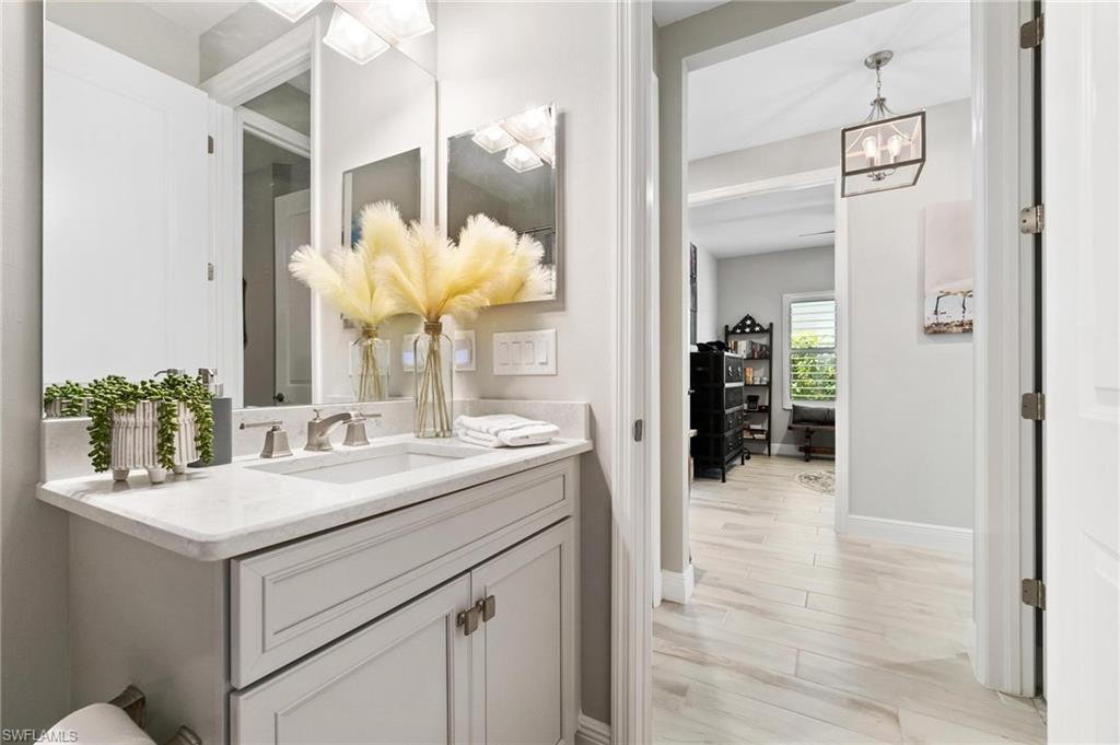 2298 Marquesa Circle Naples, FL 34112 - Photo 19 of 50 a bathroom with a sink and a mirror